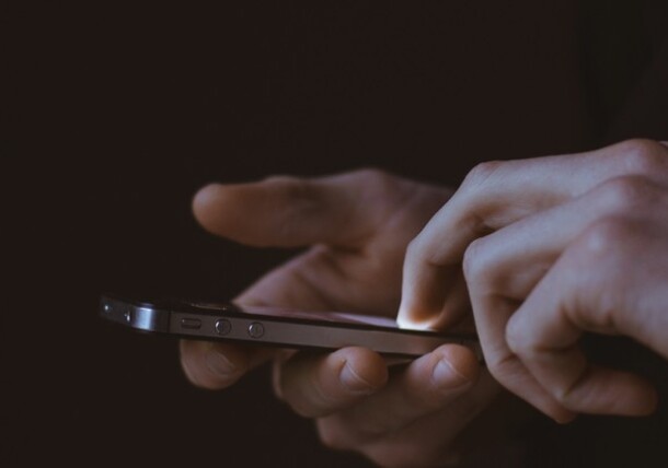 User tapping on her phone